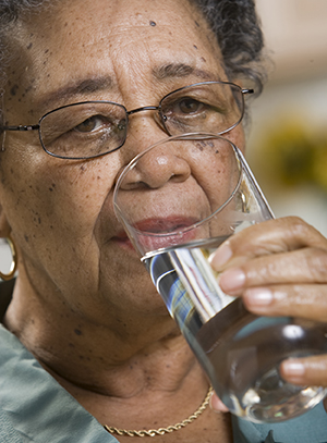 Woman drinking glass of water.